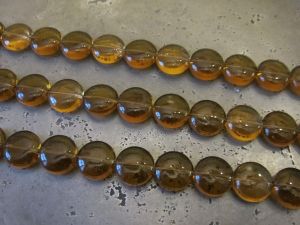 Glass bead coin small amber